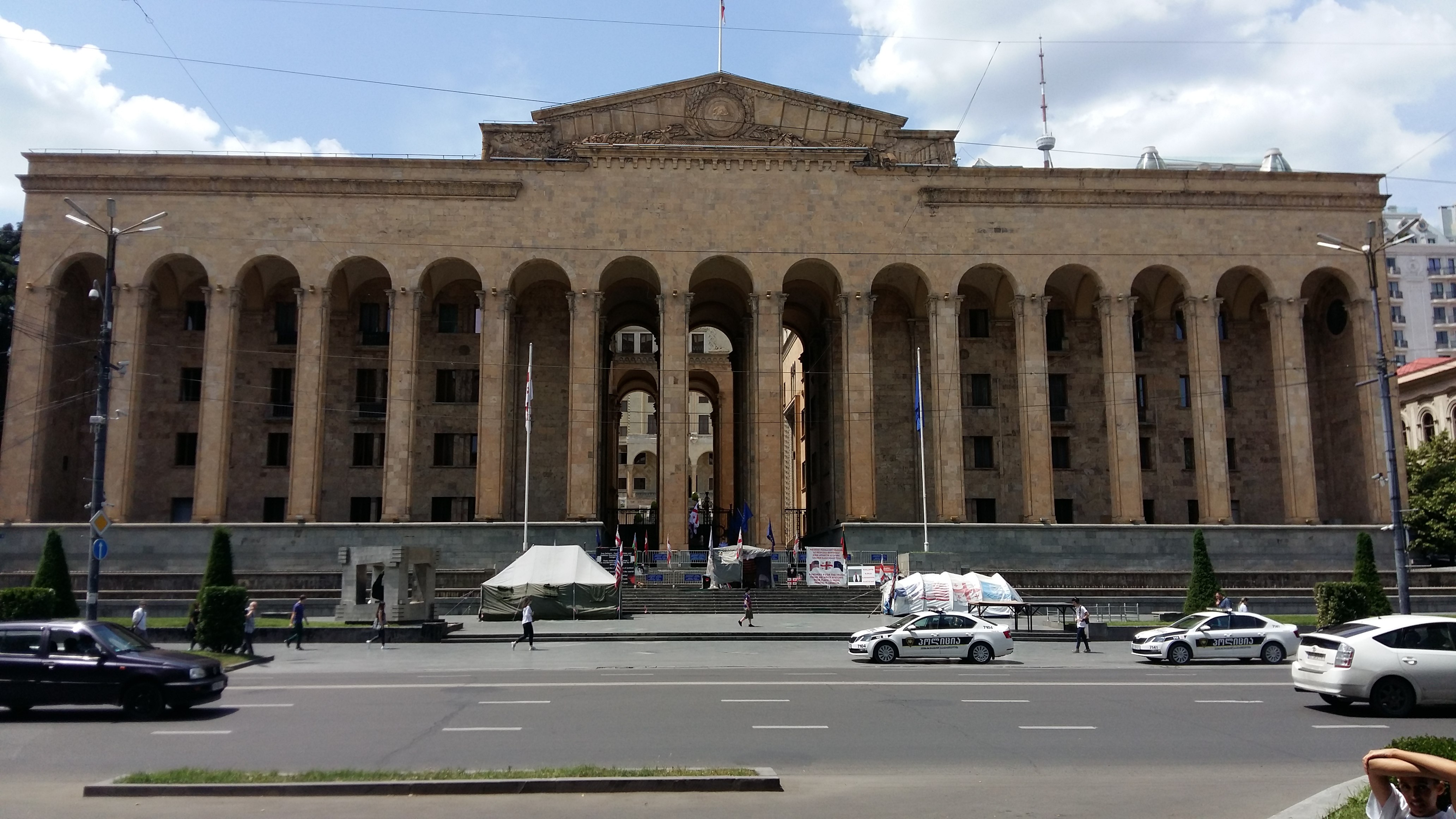 The Parliament of Georgia, with the tents of Malkhaz Machalikashvili and Zaza Saralidze in front.