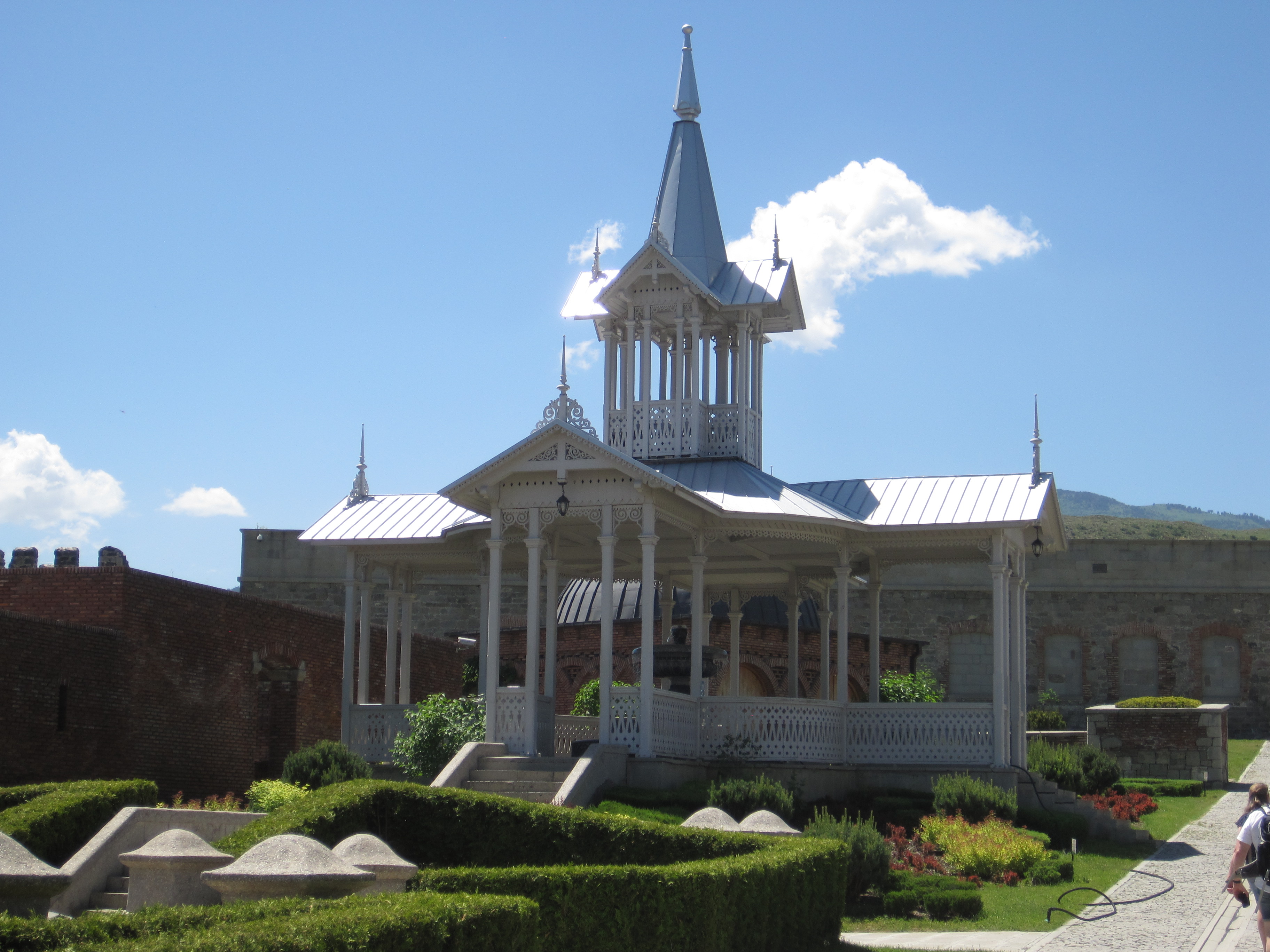Garden gazebo with cupola and pointed roof.
