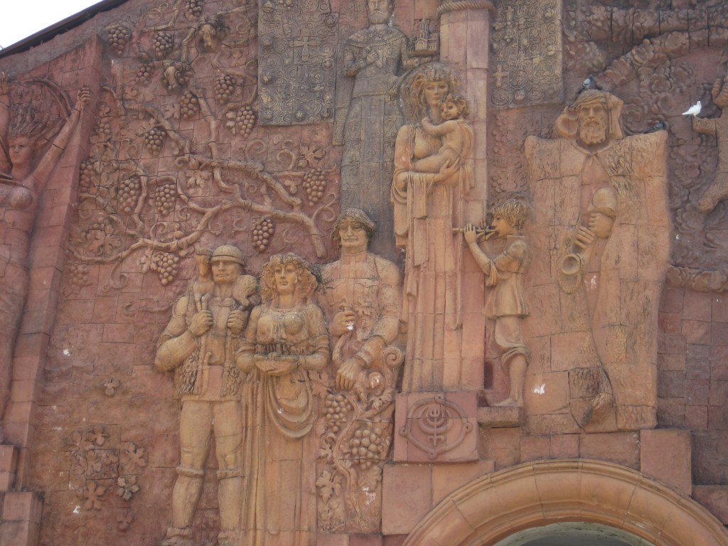 Relief sculpture of standing figures and grape vines on the wall of the Green Bazaar in Kutaisi, Georgia.